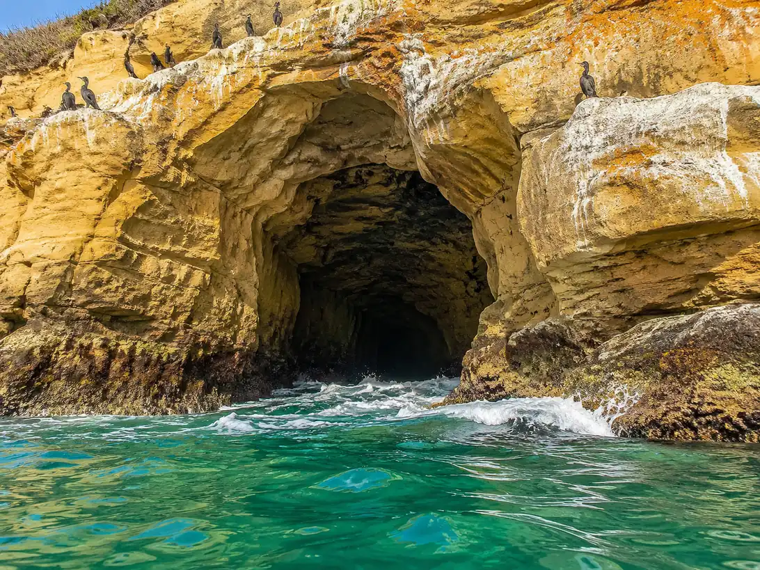 The sandstone mouth of one of the seven caves, seen from the water